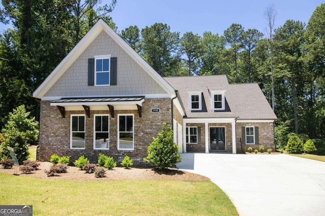 view of front of home featuring covered porch and a front lawn