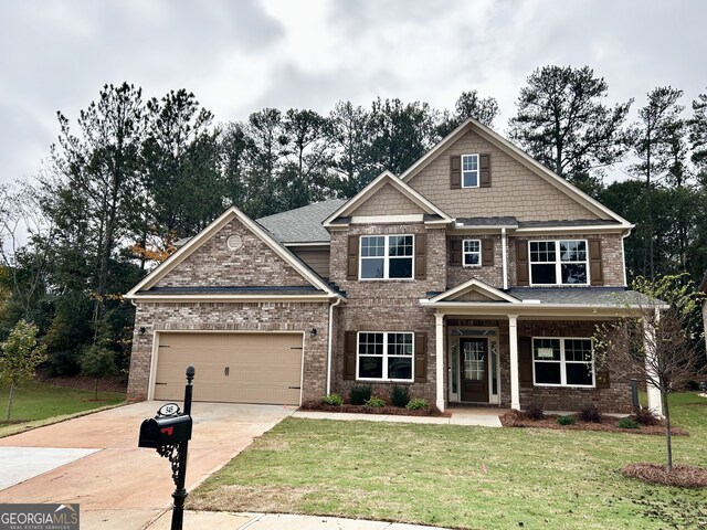 craftsman-style house with a front yard, a porch, and a garage