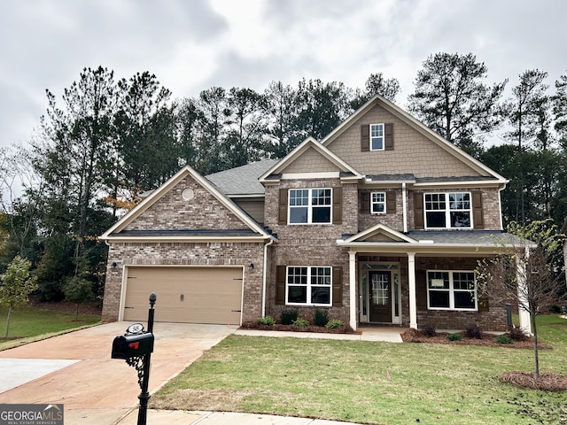 craftsman inspired home featuring a garage and a front yard