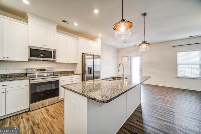 kitchen with sink, white cabinetry, and stainless steel appliances