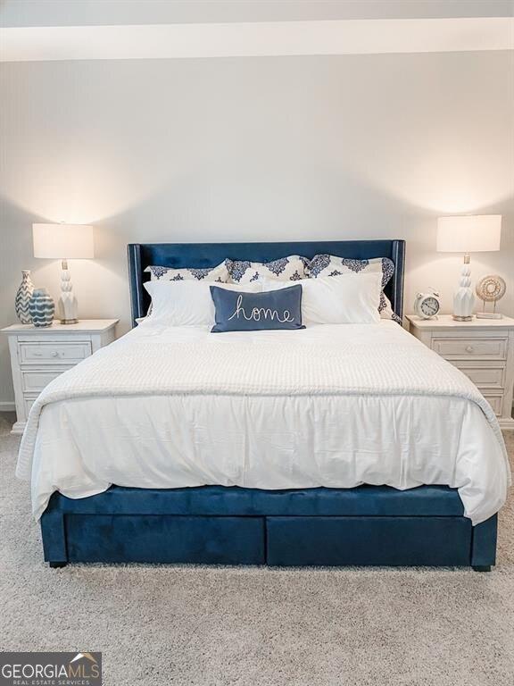 bedroom with light colored carpet