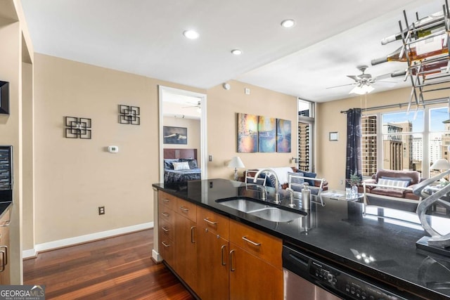 kitchen with stainless steel dishwasher, dark hardwood / wood-style floors, ceiling fan, and sink