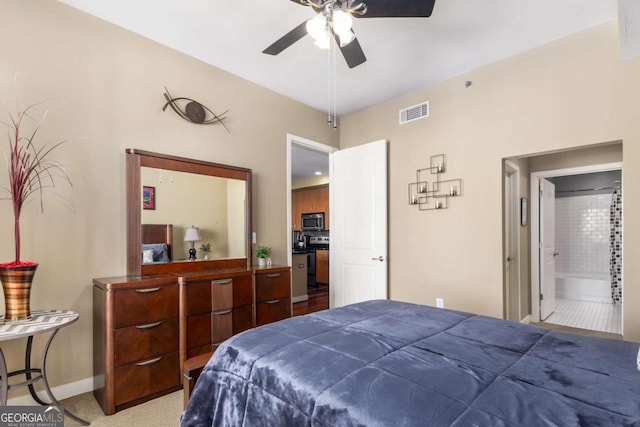 bedroom with carpet flooring, ensuite bath, and ceiling fan