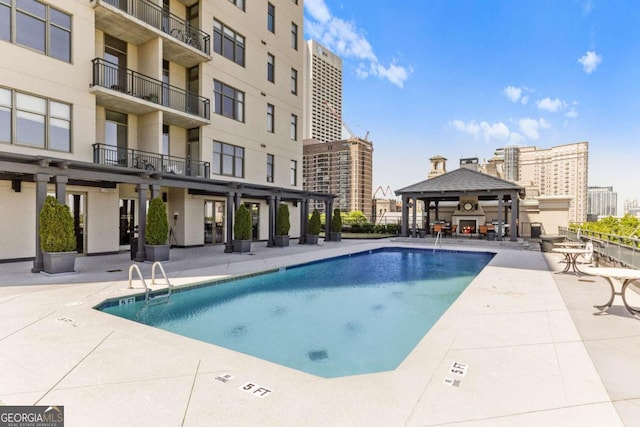 view of swimming pool featuring a gazebo and a patio area