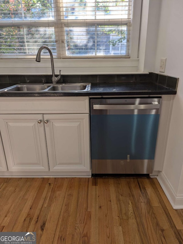 kitchen featuring white cabinetry, dishwasher, hardwood / wood-style flooring, and sink