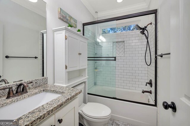 full bathroom with vanity, toilet, crown molding, and bath / shower combo with glass door