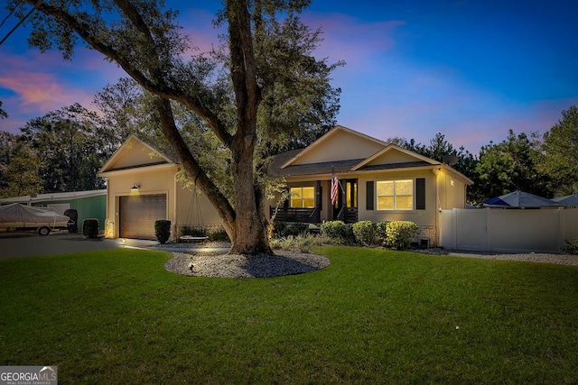 ranch-style house with a yard and a garage