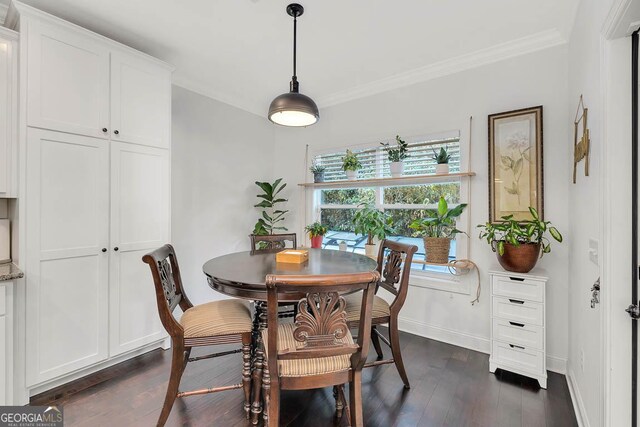 dining area featuring crown molding and dark wood-type flooring