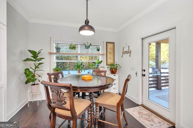 dining room with crown molding and dark hardwood / wood-style flooring