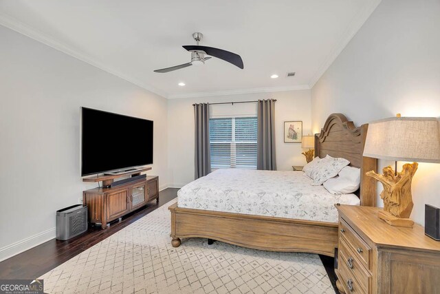 bedroom featuring ceiling fan, dark hardwood / wood-style floors, and crown molding