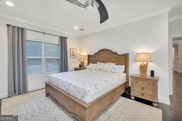 bedroom with ceiling fan, wood-type flooring, and ornamental molding