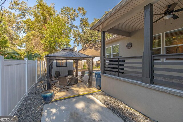 view of patio featuring a gazebo, ceiling fan, and an outdoor hangout area