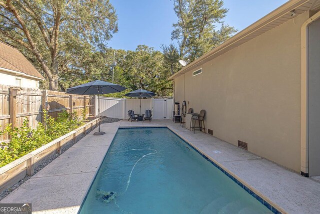 view of swimming pool featuring a patio area