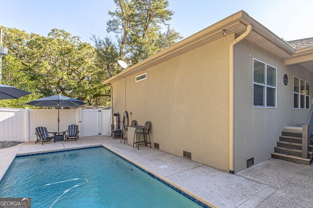 view of swimming pool featuring a patio area