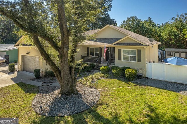 ranch-style house featuring a front yard and a garage