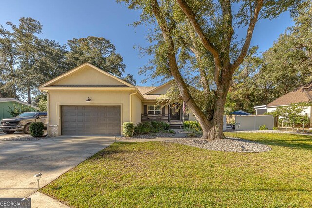 ranch-style home with a front yard and a garage