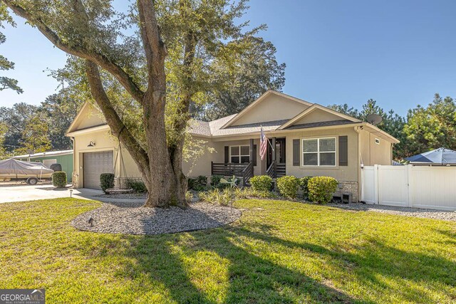 single story home with a garage and a front lawn