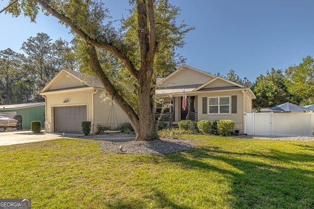 ranch-style house featuring a front yard and a garage