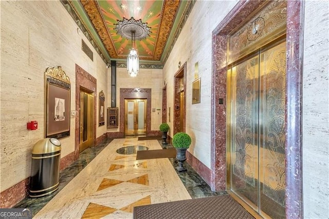 corridor with elevator and ornamental molding