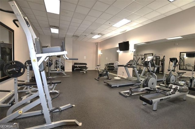 gym with a paneled ceiling