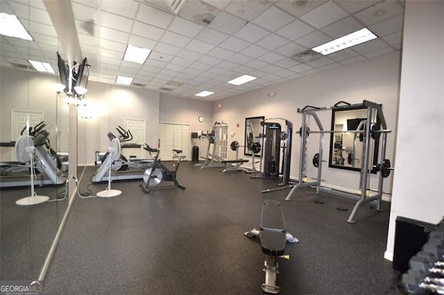 exercise room featuring a paneled ceiling