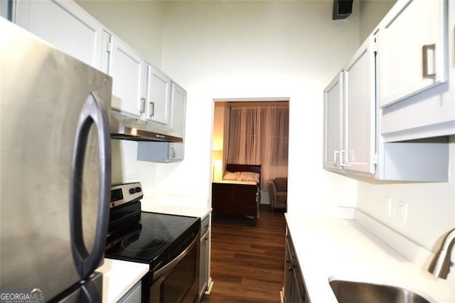 kitchen featuring dark hardwood / wood-style flooring, white cabinets, stainless steel appliances, and sink