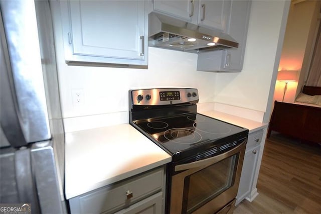 kitchen featuring hardwood / wood-style floors and electric range