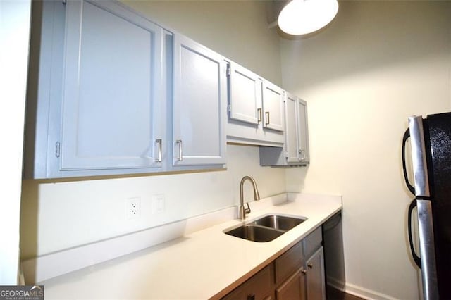 kitchen with stainless steel fridge and sink