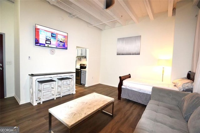 bedroom with beam ceiling and dark hardwood / wood-style flooring