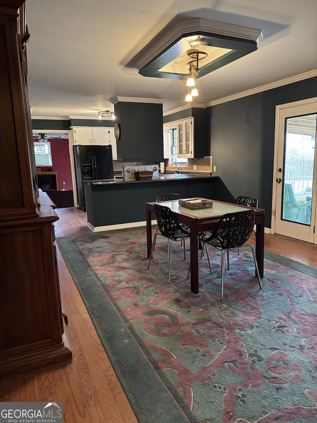 dining area with a wealth of natural light, ceiling fan, dark hardwood / wood-style floors, and ornamental molding