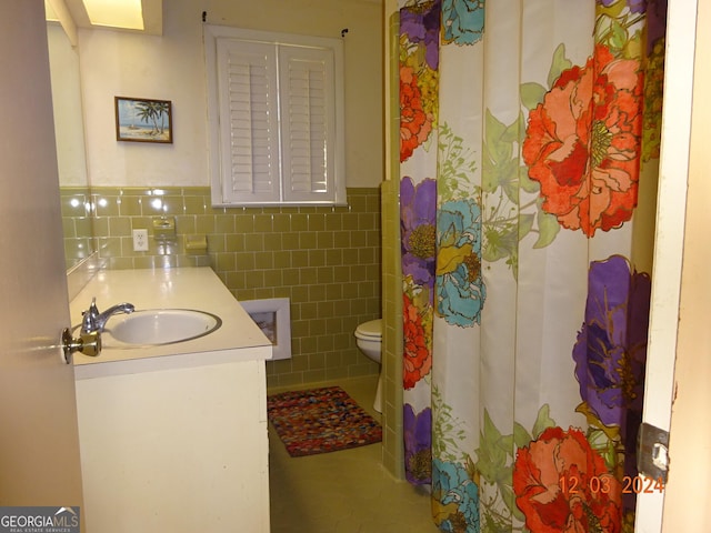 bathroom with tile patterned flooring, vanity, tile walls, and toilet