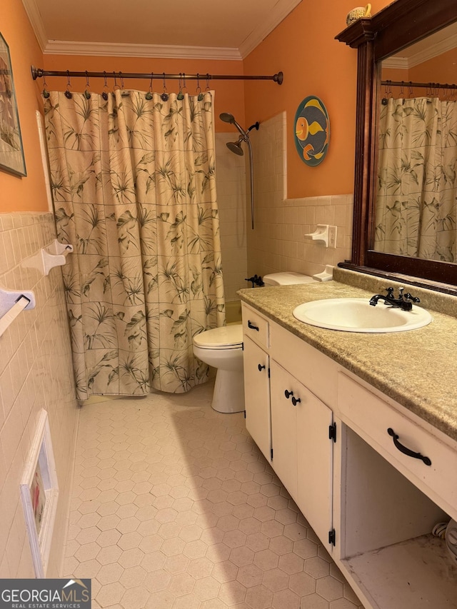 bathroom featuring vanity, a shower with curtain, toilet, ornamental molding, and tile walls