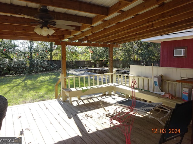 wooden deck with a lawn and ceiling fan