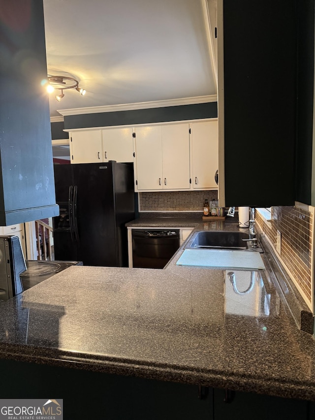 kitchen with dark stone counters, black appliances, white cabinets, crown molding, and sink