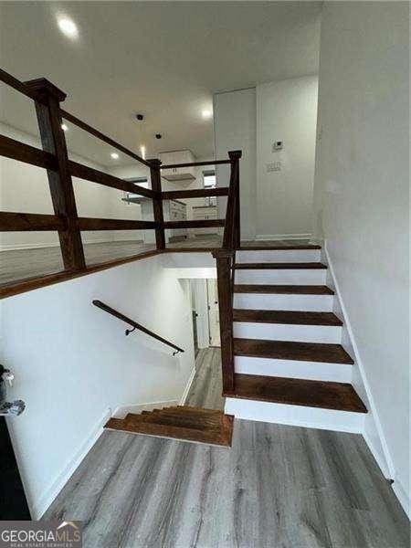 staircase with wood-type flooring