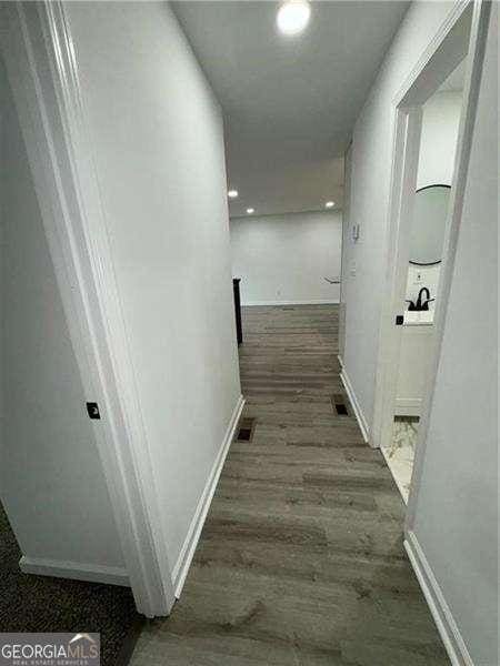 corridor featuring dark hardwood / wood-style flooring