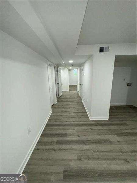 corridor with dark hardwood / wood-style floors