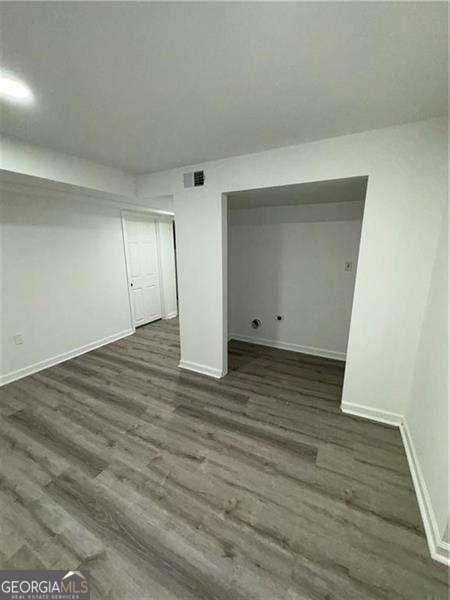 basement with dark hardwood / wood-style flooring