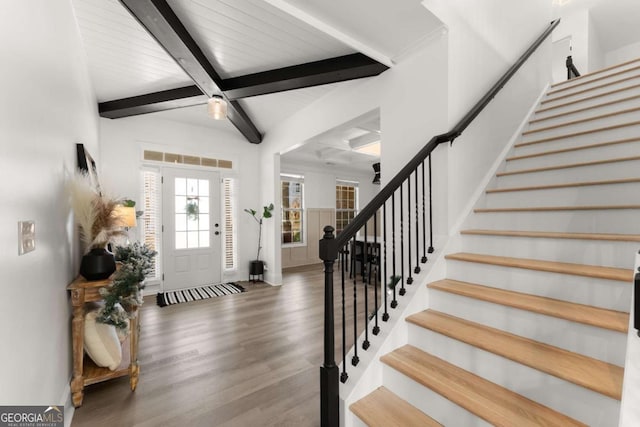 entrance foyer featuring beam ceiling and dark hardwood / wood-style floors