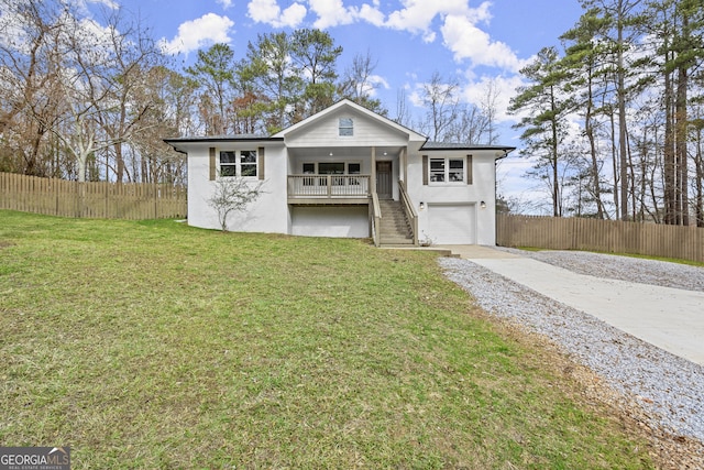 view of property with a front yard, a garage, and covered porch