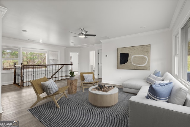 living room with crown molding, hardwood / wood-style floors, and ceiling fan