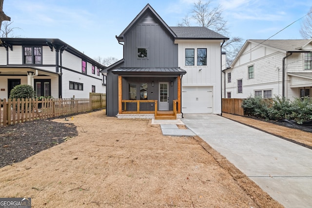 modern inspired farmhouse with a porch and a garage