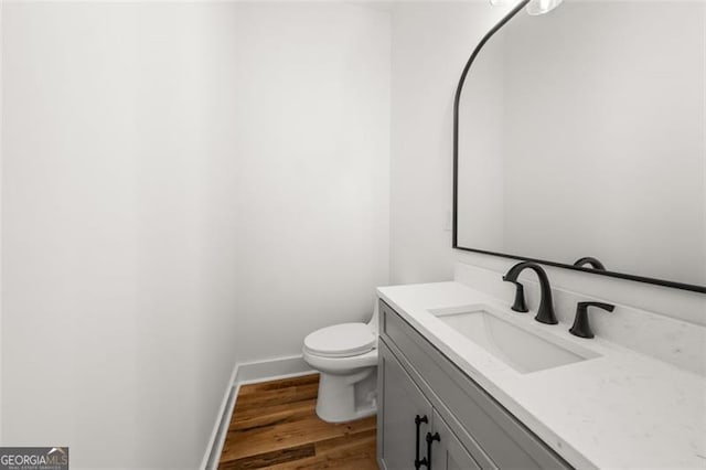 bathroom with vanity, hardwood / wood-style floors, and toilet