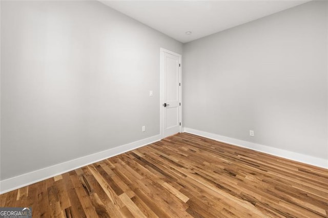 empty room with hardwood / wood-style flooring