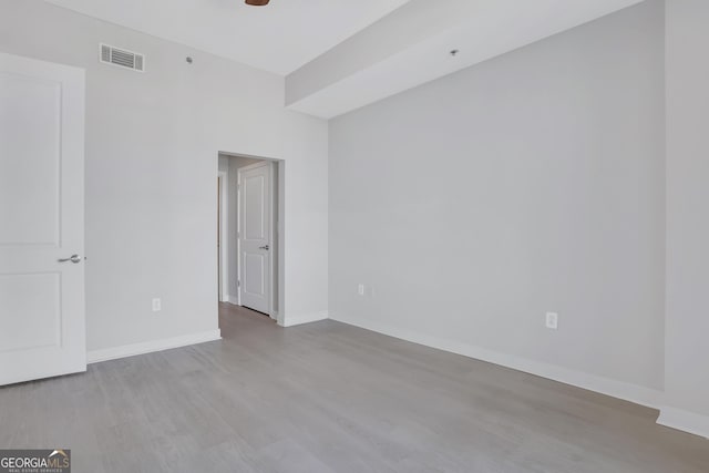 empty room featuring ceiling fan and light hardwood / wood-style floors