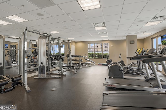 gym featuring plenty of natural light and a paneled ceiling