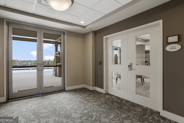 doorway to outside featuring french doors and dark carpet