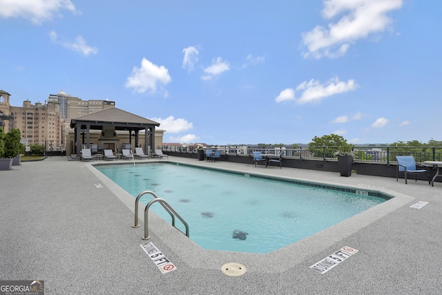 view of swimming pool featuring a gazebo and a patio area