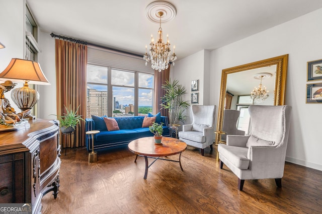 sitting room featuring dark wood-type flooring and a notable chandelier