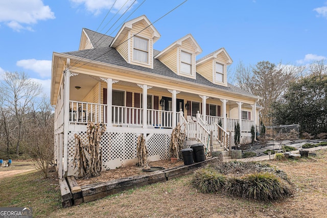 cape cod home featuring covered porch